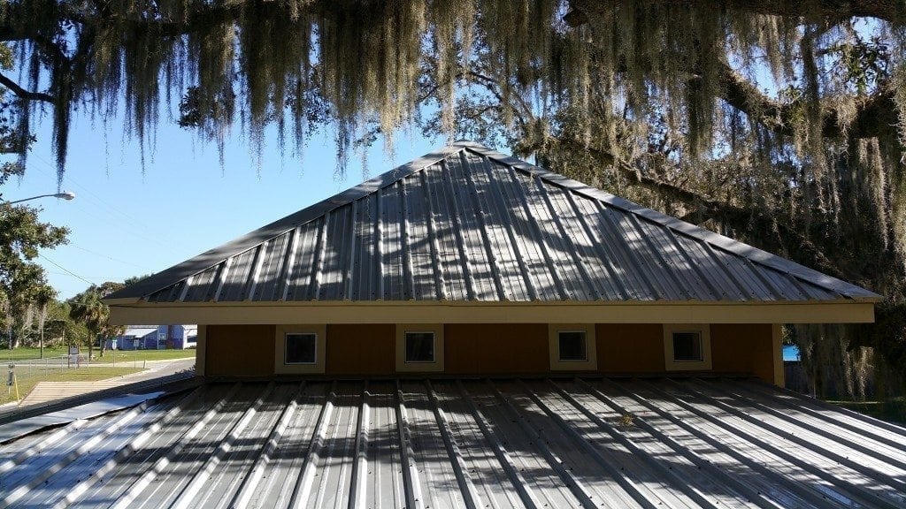 Is Your Roof Under Attack? Roofs in Lakeland and the rest of Florida present the perfect living quarters for algae, moss, and other mold. The worst culprit is a type of bacteria called Gloeocapsa Magma. It creates black streaks across your roofing – and as it eats the limestone in your shingles, it spreads. The result is ugly and dangerous. Without regular cleaning, this bacteria will deteriorate your roofing. Algae growth on the roof can lead to premature granule loss. It makes your roof to appear much older than it is, and it creates issues that cost money and take time to fix. No roofing material is safe from this kind of wear and tear: It affects asphalt roofing, slate, metal, and tile roofs alike. Here’s the good news. There is an alternative. A professional roof cleaning will restore the original appearance of your roof and keep it from declining prematurely.