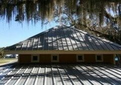 Is Your Roof Under Attack? Roofs in Lakeland and the rest of Florida present the perfect living quarters for algae, moss, and other mold. The worst culprit is a type of bacteria called Gloeocapsa Magma. It creates black streaks across your roofing – and as it eats the limestone in your shingles, it spreads. The result is ugly and dangerous. Without regular cleaning, this bacteria will deteriorate your roofing. Algae growth on the roof can lead to premature granule loss. It makes your roof to appear much older than it is, and it creates issues that cost money and take time to fix. No roofing material is safe from this kind of wear and tear: It affects asphalt roofing, slate, metal, and tile roofs alike. Here’s the good news. There is an alternative. A professional roof cleaning will restore the original appearance of your roof and keep it from declining prematurely.